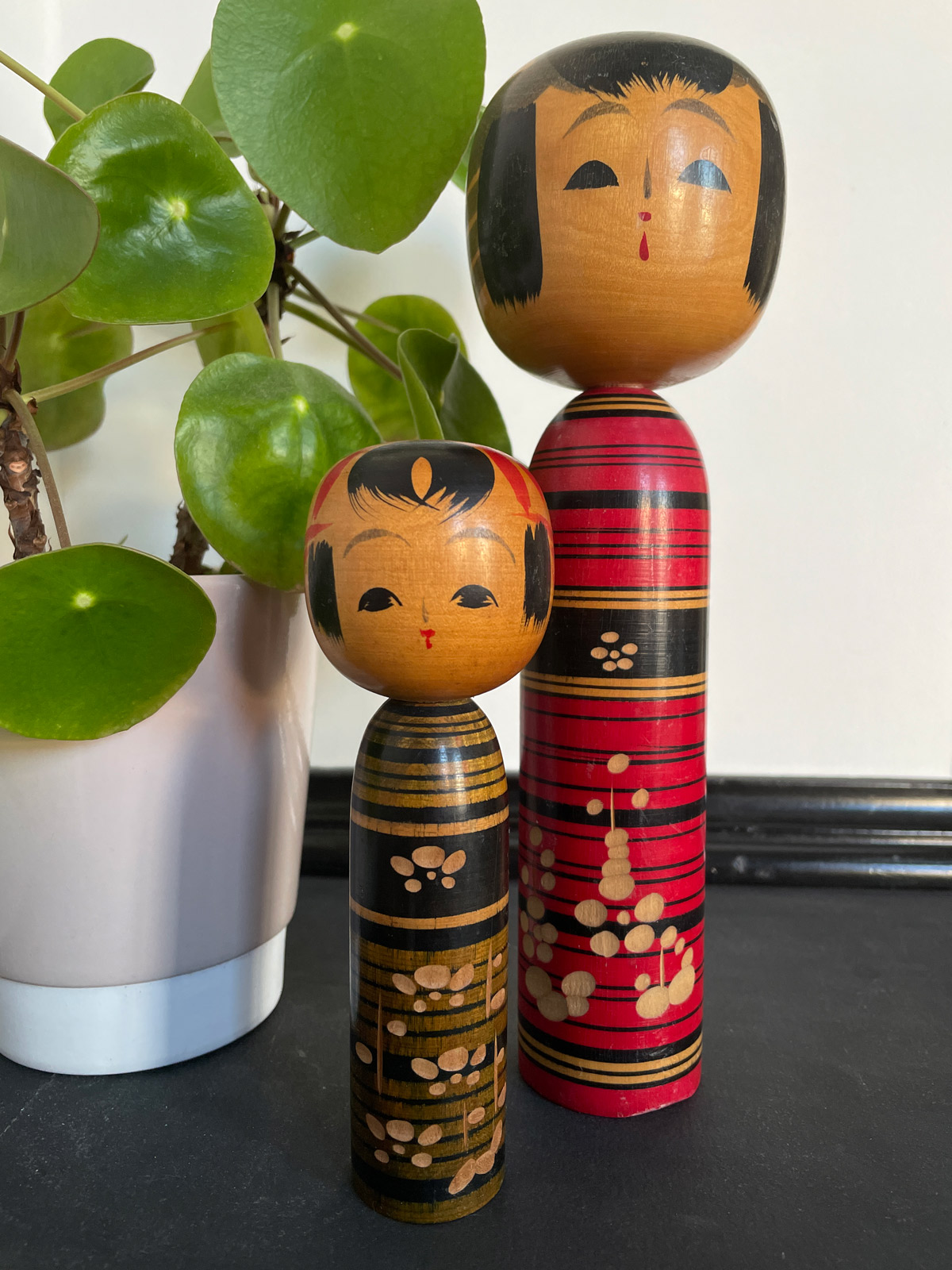 Two vintage Kokeshi with stripes and carvings