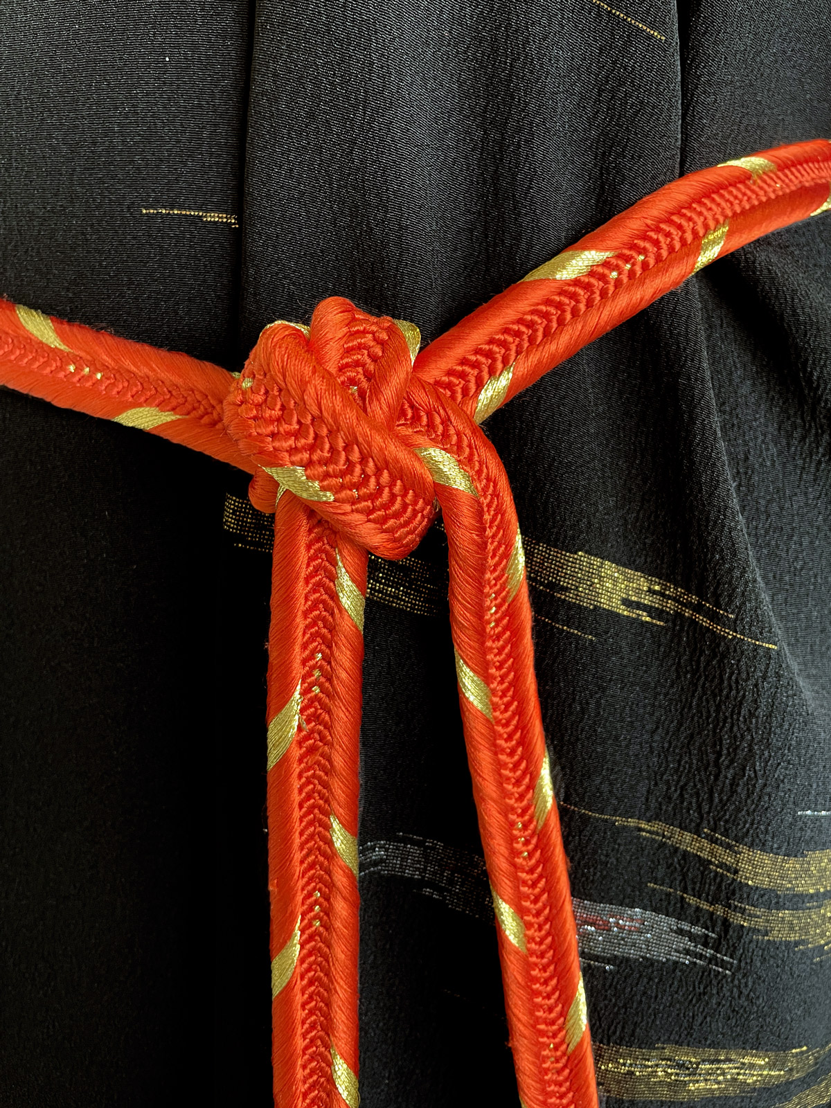 Bright orange silk cord with golden details