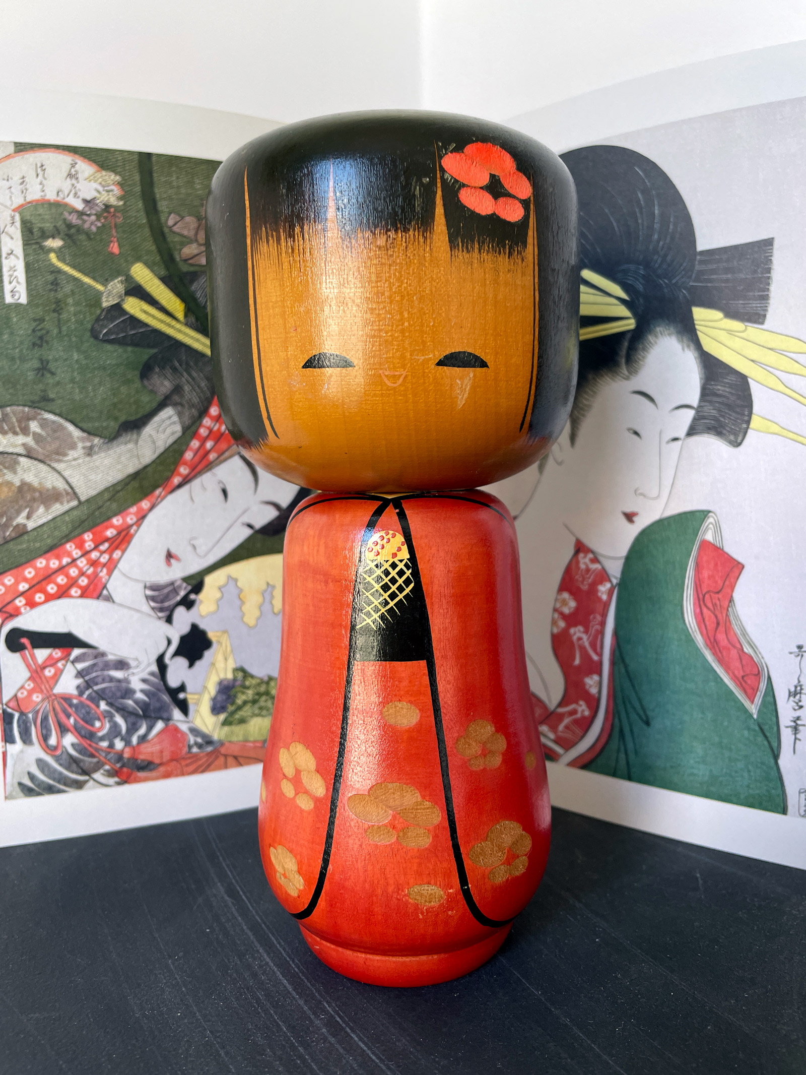 Cute Kokeshi doll in red kimono